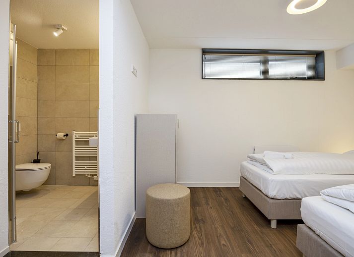 Cozy sitting area with wine glasses in 8-person house 8C, Westerbork.