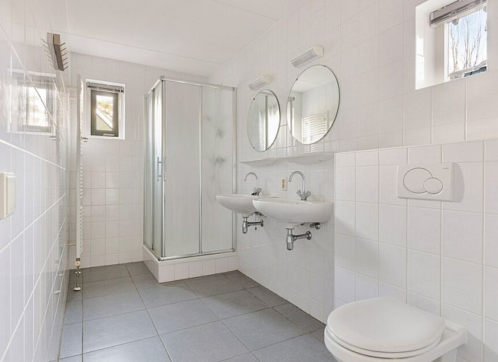 Cozy living room of Zandduin Villa 12 in Hooghalen, Middle Drenthe, overlooking terrace and green surroundings.