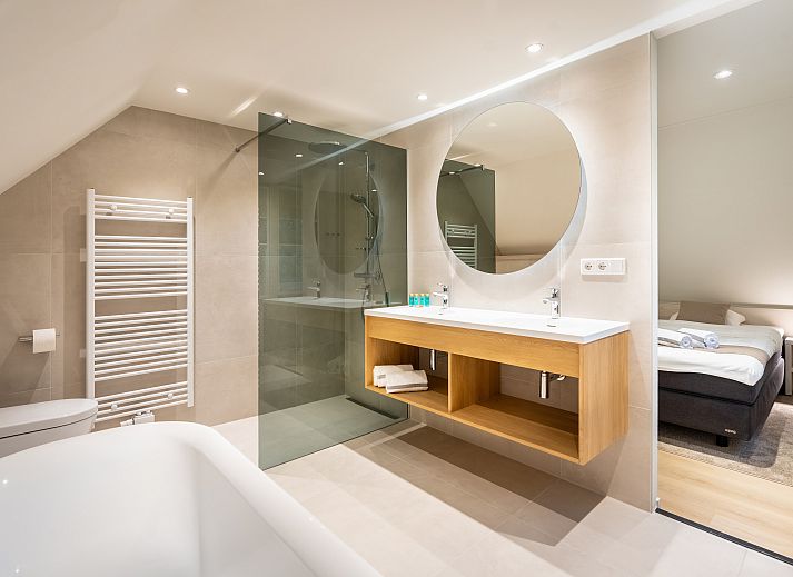 Stylish kitchen in Hof van Saksen 8-bed farmhouse 8L, Nooitgedacht, Drenthe, with modern appliances and wine.