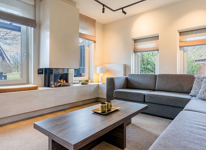 Spacious dining room in Hof van Saksen, 12-bed Luxury Culinary Farmhouse in Nooitgedacht, Drenthe with modern furnishings.