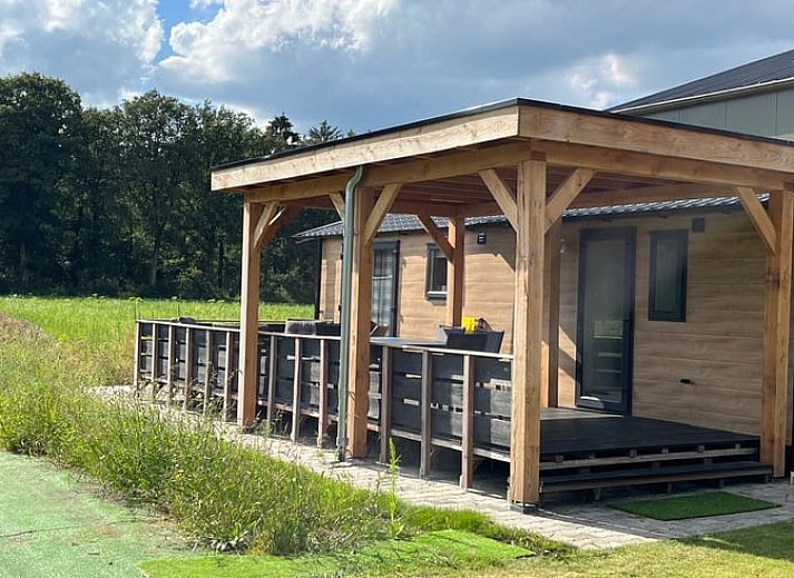 Porch of Holiday Home in Eeserveen, Drenthe overlooking green fields.