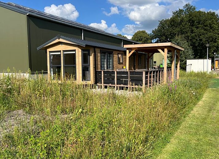Porch of Holiday Home in Eeserveen, Drenthe overlooking green fields.