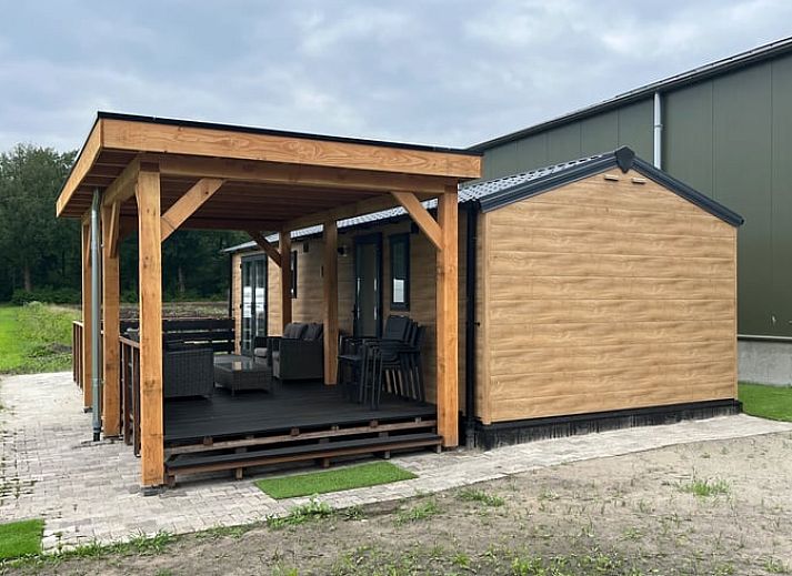 Porch of Holiday Home in Eeserveen, Drenthe overlooking green fields.