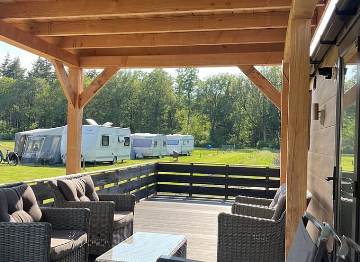 Porch of Holiday Home in Eeserveen, Drenthe overlooking green fields.