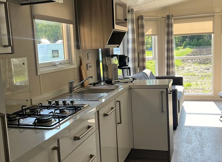 Porch of Holiday Home in Eeserveen, Drenthe overlooking green fields.
