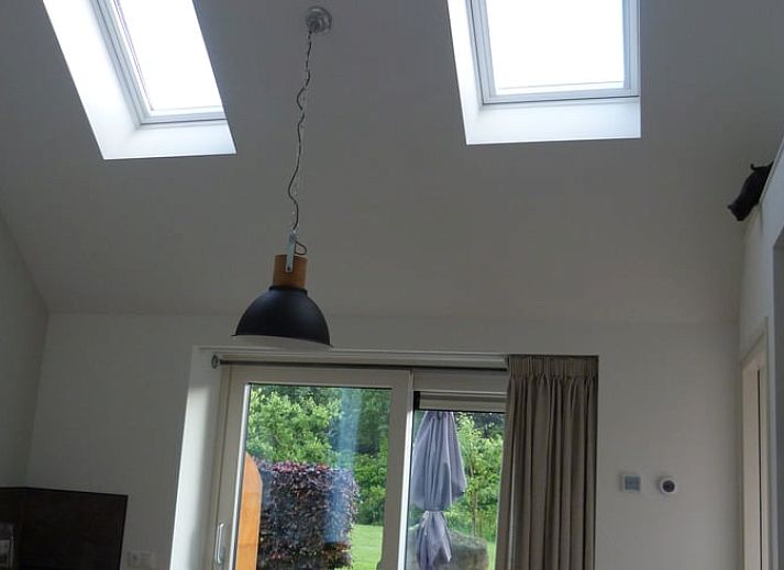 Charmanter Eingang zum Ferienhaus in Smilde, Zentral-Drenthe, mit offenen Fensterlaeden und Blumen.