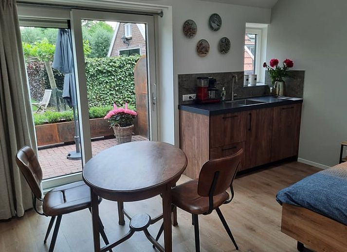 Cozy dining area in Holiday Home in Smilde, Central Drenthe overlooking terrace.
