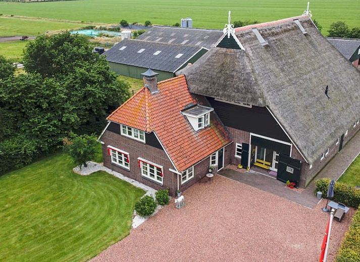 Esszimmer im Ferienhaus in Een, Nord-Drenthe, mit Blick auf den Garten und Kunst an der Wand.
