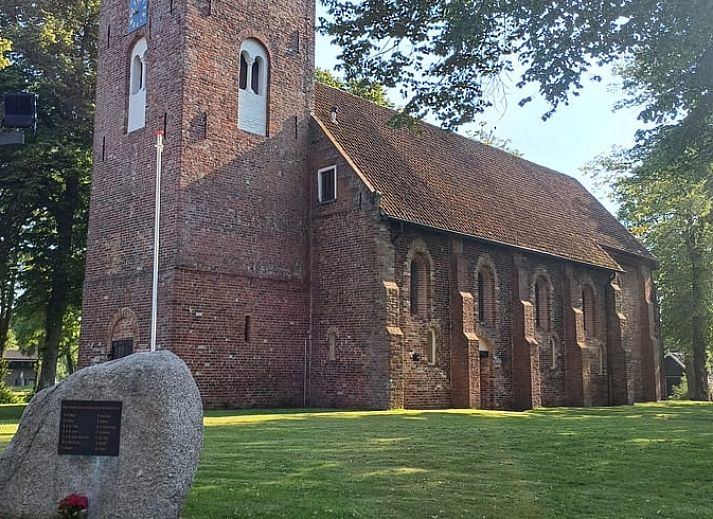 Gemuetliches Wohnzimmer des Ferienhauses in Norg, Nord-Drenthe, mit moderner Einrichtung und bequemer Sitzecke.