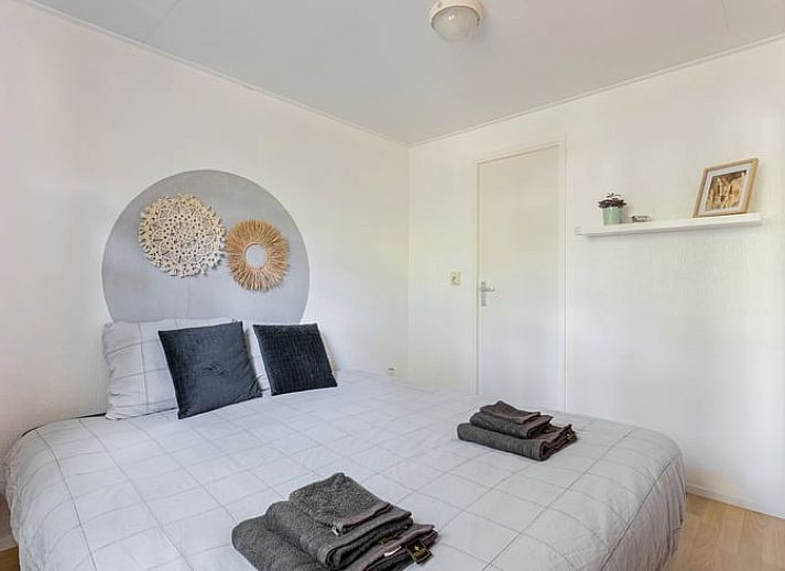 Binnenruimte van Huisje in Norg, vakantiehuis in Noord Drenthe, met stoel en uitzicht op de groene omgeving.