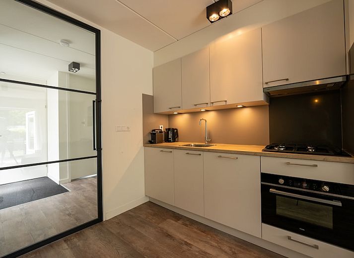 Cozy living room in H6A Comfort bungalow, Borger, North Drenthe, overlooking terrace and green nature.