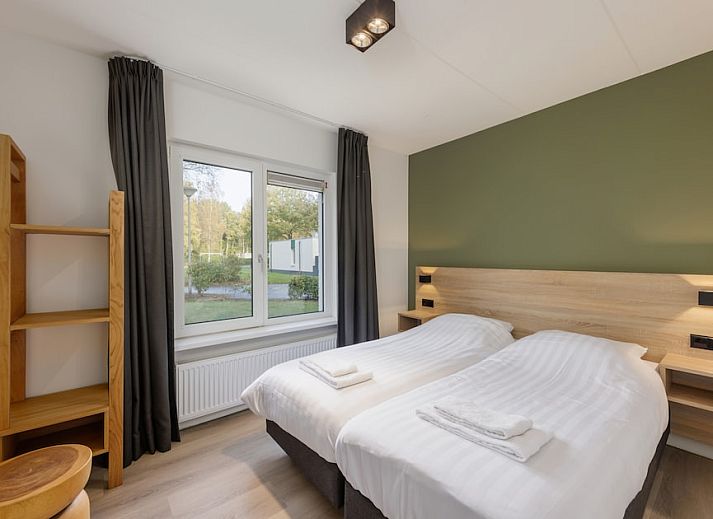 Cozy living room in H6A Comfort bungalow, Borger, North Drenthe, overlooking terrace and green nature.