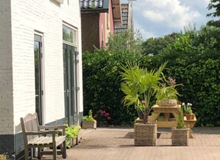 Cozy interior of Cottage in Tynaarlo, North Drenthe, with an archway to the bedroom.