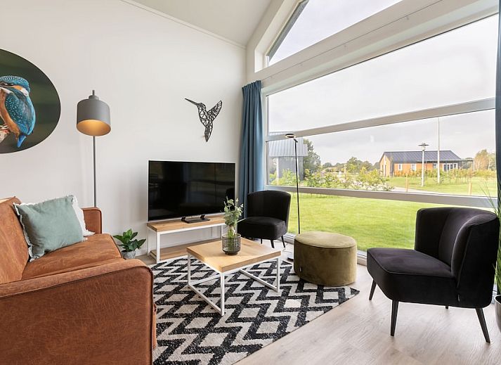 Bungalow Drentsche E in Tynaarlo, North Drenthe, with sunny porch and views of a serene pond in the natural surroundings.