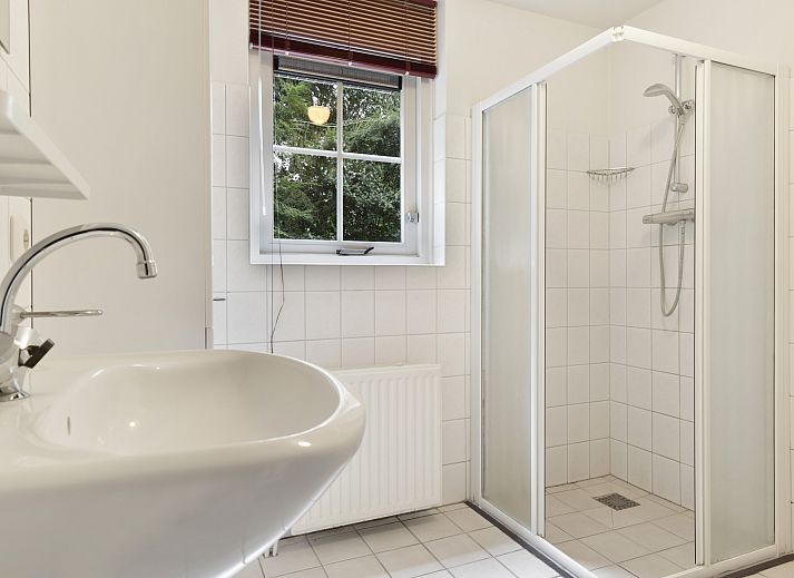 Cozy sitting area with fireplace in Het Land van Bartje 6-person vacation home in Ees, Drenthe.