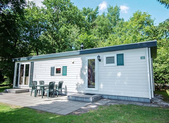 Cozy living room in Het Land van Bartje, 4-person mobile home in Ees, Drenthe, with comfortable interior and views of the green surroundings.