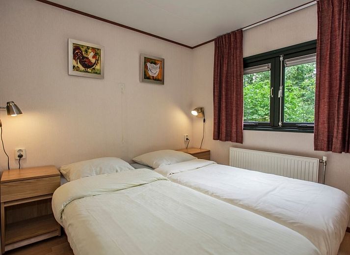 Cozy living room in Het Land van Bartje 4-person mobile home 4BC, Ees, Drenthe, overlooking green surroundings.