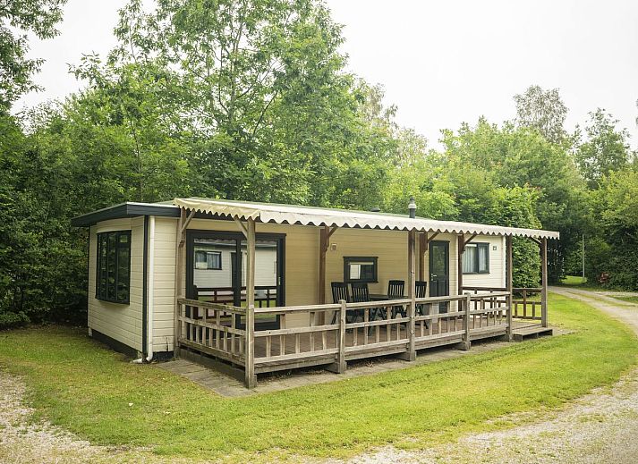 Enjoy the green surroundings at Het Land van Bartje, 4-person mobile home 4BCV in Ees, Drenthe, with children playing on the grass.