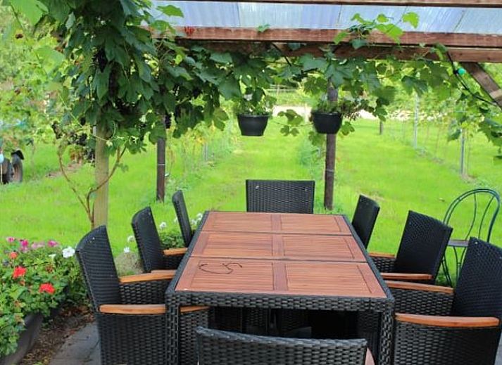 Sliding glass doors at Holiday Home in Nietap, North Drenthe, offer views of expansive fields.