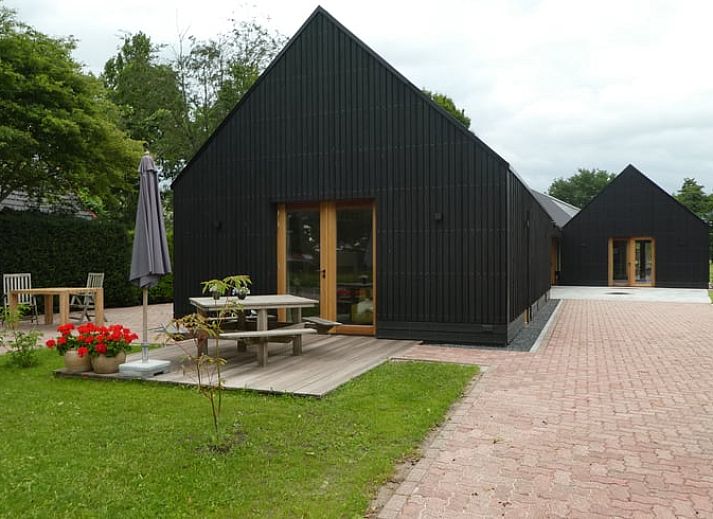 Huisje in Bunne, vakantiehuis in Noord Drenthe, Drenthe met moderne veranda en bloeiende tuin, ideaal voor natuurliefhebbers.