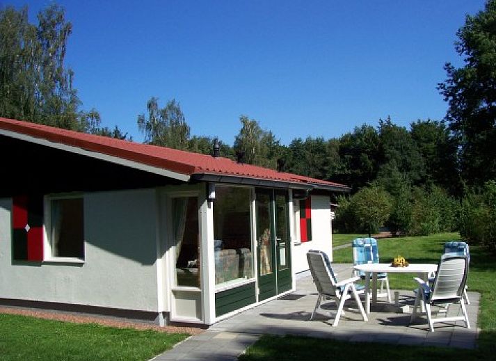 Cozy living room of clean holiday bungalow in Exloo, Drenthe overlooking the garden.