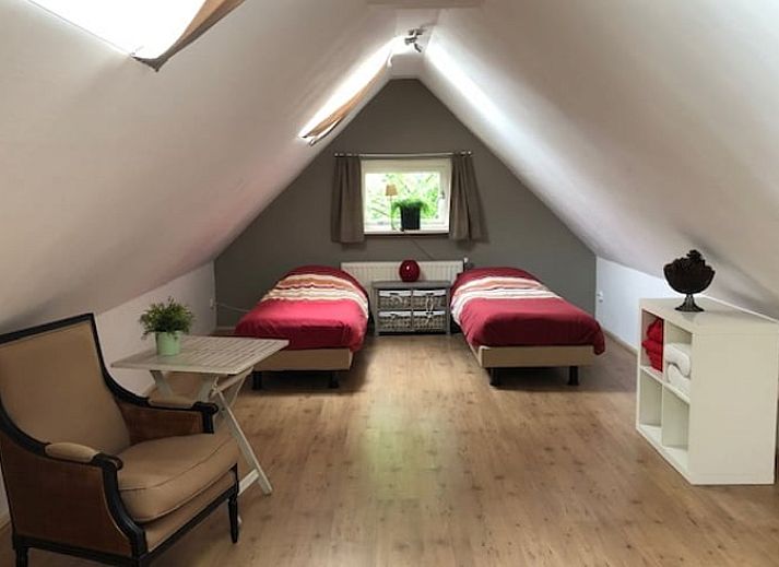 Cozy garden at Holiday Home in Exloo, Drenthe, with picnic table and flowering plants.