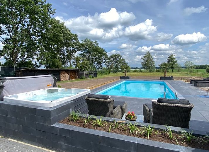 Vacation home in Exloo, Drenthe, with shady porch and manicured garden.