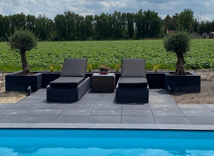 Vacation home in Exloo, Drenthe, with shady porch and manicured garden.