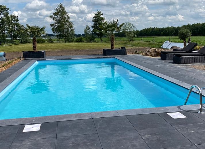 Vacation home in Exloo, Drenthe, with shady porch and manicured garden.
