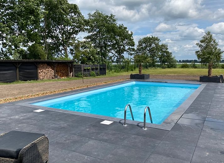 Vacation home in Exloo, Drenthe, with shady porch and manicured garden.