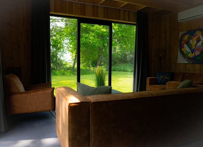 Modern interior space of Holiday Home in Dalerveen, Southeast Drenthe with coffee maker and garden view.