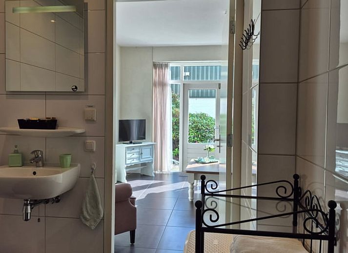 Cozy living room in Holiday Home in Dalerveen, Southeast Drenthe, with comfortable sofas and views of the garden.