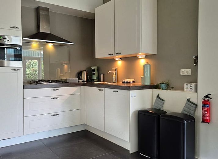 Cozy living room in Holiday Home in Dalerveen, Southeast Drenthe, with comfortable sofas and views of the garden.