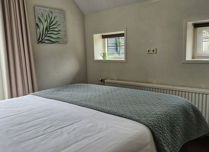 Cozy living room in Holiday Home in Dalerveen, Southeast Drenthe, with comfortable sofas and views of the garden.