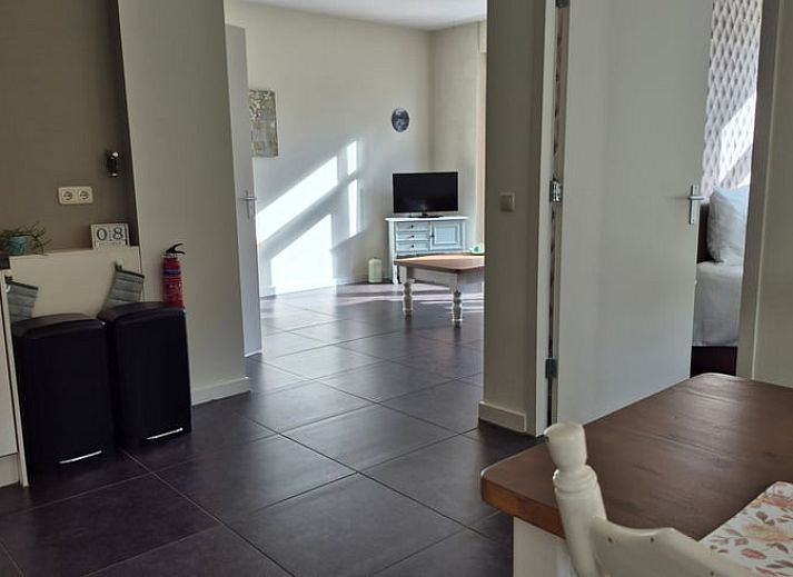 Cozy living room in Holiday Home in Dalerveen, Southeast Drenthe, with comfortable sofas and views of the garden.