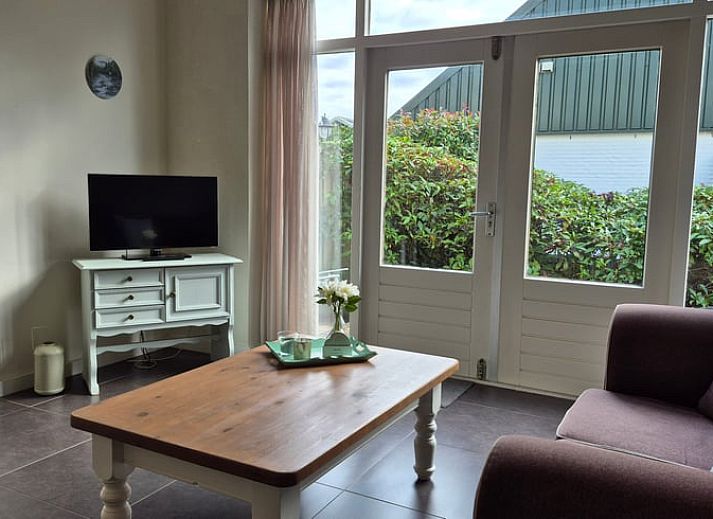 Cozy living room in Holiday Home in Dalerveen, Southeast Drenthe, with comfortable sofas and views of the garden.