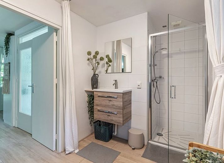 Lichte woonkamer in Vakantiehuis in Schoonoord, Zuidoost Drenthe met moderne inrichting en uitzicht op groene tuin.