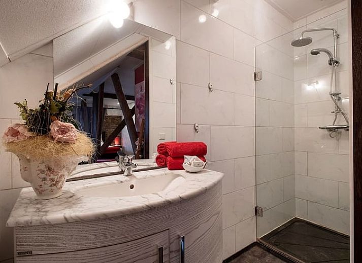 Gezellige slaapkamer in Vakantiehuisje in Stieltjeskanaal, Drenthe met hemelbed en warme inrichting.