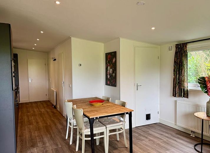 Enjoy the view from the veranda of Holiday Home in Odoornerveen, Drenthe, with comfortable seating areas and green fields.