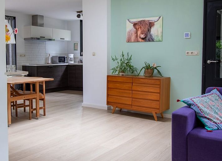 Vacation home in Doldersum, Southwest Drenthe, offers a rustic wooden veranda surrounded by green nature for a relaxing stay.