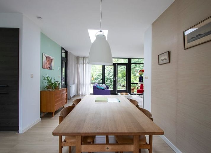 Vacation home in Doldersum, Southwest Drenthe, offers a rustic wooden veranda surrounded by green nature for a relaxing stay.