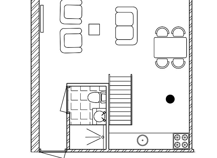 Essecke im Ferienhaus DG1706, Havelte, Drenthe mit bunten Stuehlen und Blumen.