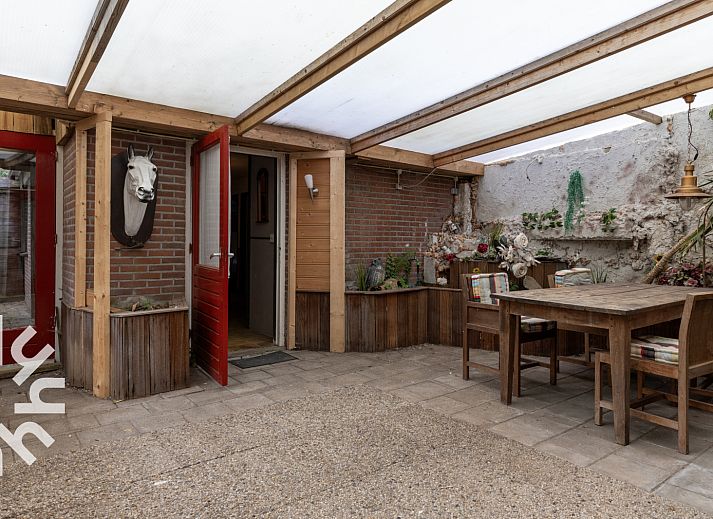 Terrace at DG183 vacation home in Diever, Drenthe, ideal for group dinners.