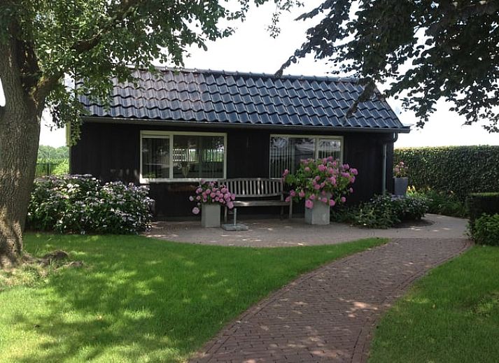 Cozy terrace at Holiday Home in Diever, Southwest Drenthe, overlooking green fields.