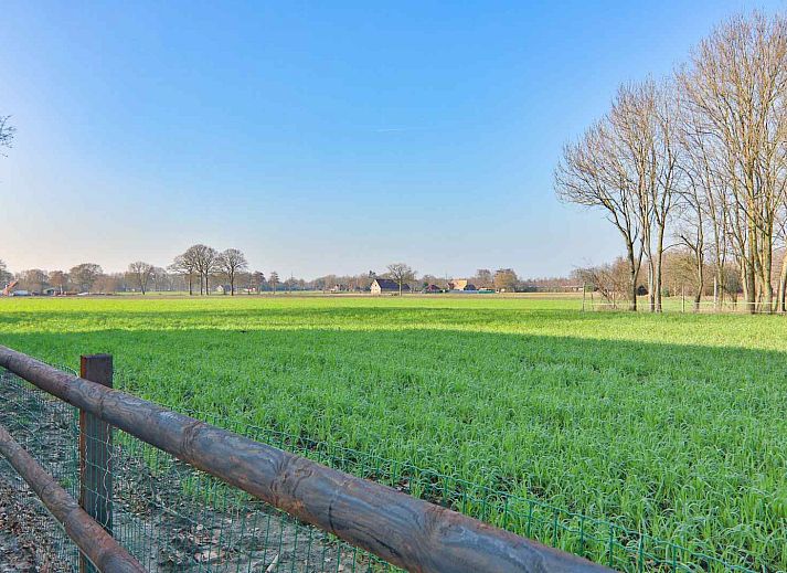 Vacation home DG1415 in Zuidwolde, Drenthe with modern facade and green surroundings.