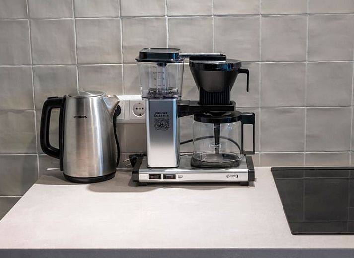 Ruime eethoek in Vakantiehuis in Dwingeloo, Zuidwest Drenthe, met houten tafel en uitzicht op de tuin.