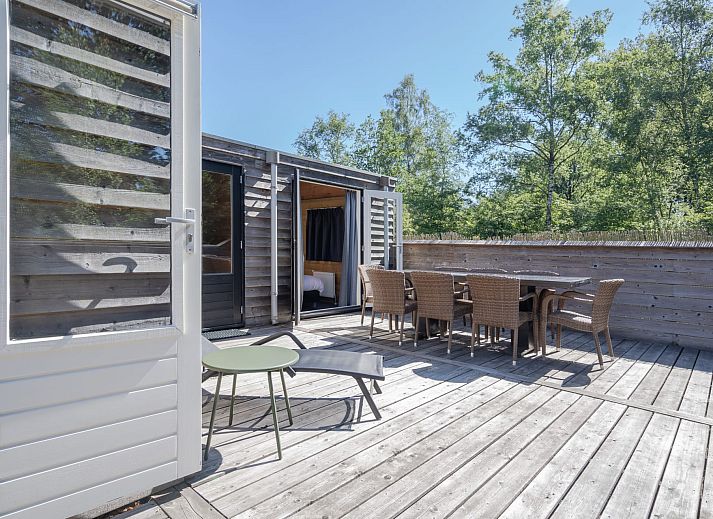 Cozy interior of Heidelodge vacation home in Dwingeloo, Southwest Drenthe, with wooden interior and modern kitchen.