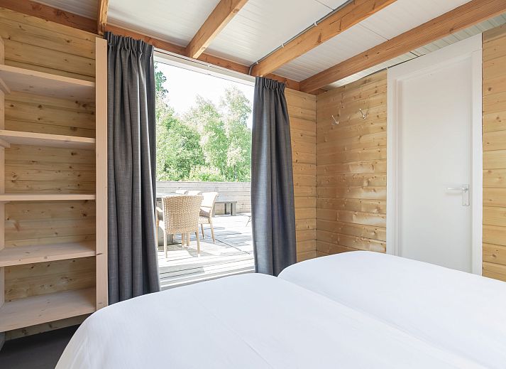 Enjoy the natural surroundings on the spacious terrace of Heidelodge, a vacation home in Dwingeloo, Southwest Drenthe.