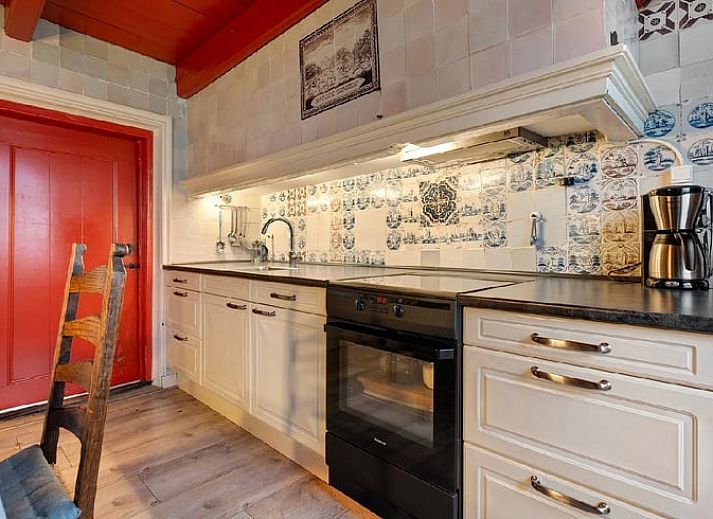 Gemuetliches Esszimmer im Ferienhaus in Ruinerwold, Suedwest-Drenthe, mit Holzbalken und laendlichem Charme.