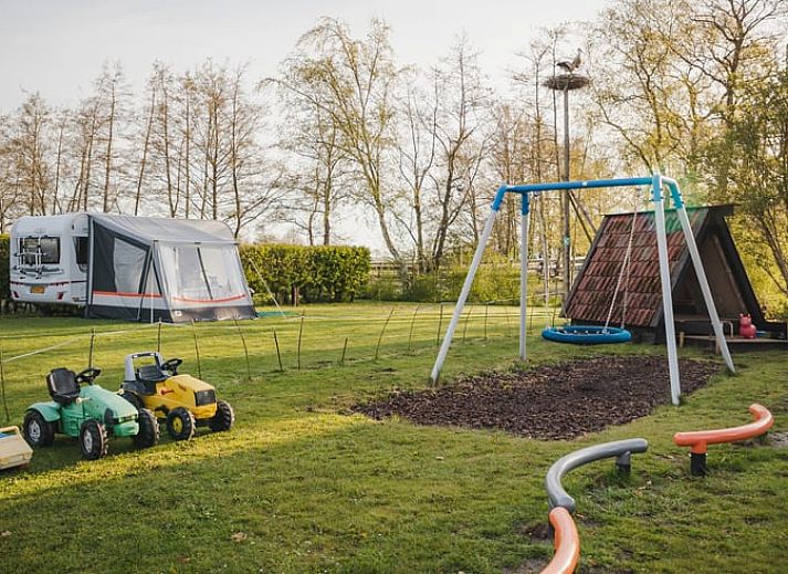 Geniessen Sie einen entspannten Abend auf der Veranda des Ferienhauses in Ruinerwold, einem Ferienhaus im Suedwesten von Drenthe, mit einer stimmungsvollen Snackplatte.